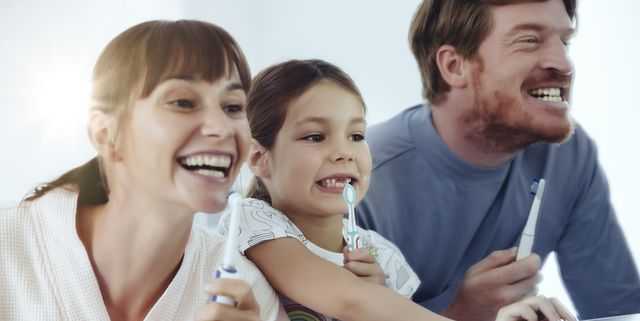 family-of-three-brushing-their-teeth