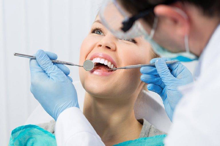Why does the dentist prefer root canal treatment?